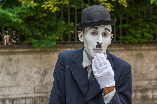 VENICE, ITALY - May 24, 2016: Male mime looking like a Charlie Chaplin in Venice with white glove and dark hat. Street male mime entertaining tourists.