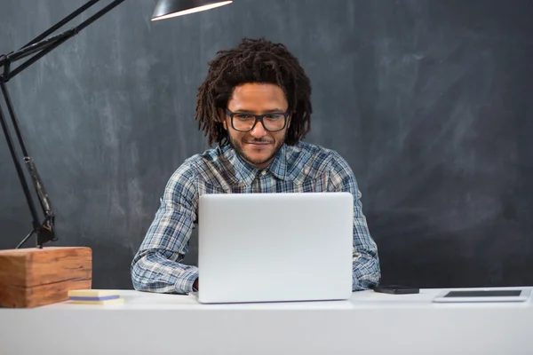 Portrait of smart businessman busy working at desk, using mobile