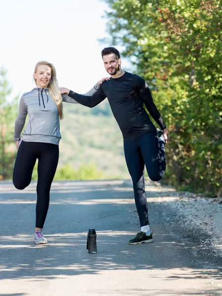 Young health couple doing stretching exercise relaxing and warm