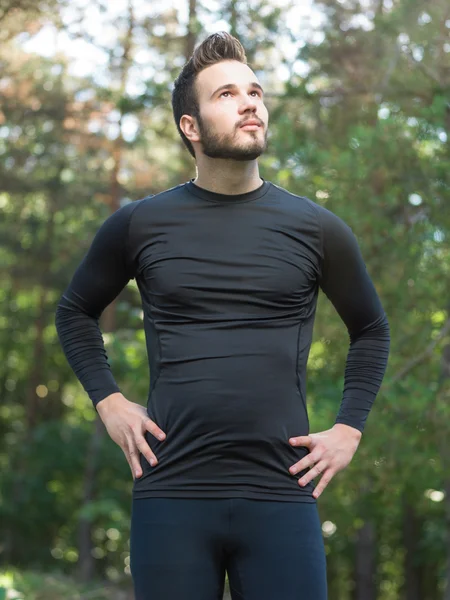 Athlete male runner running on mountain road. Running man joggin