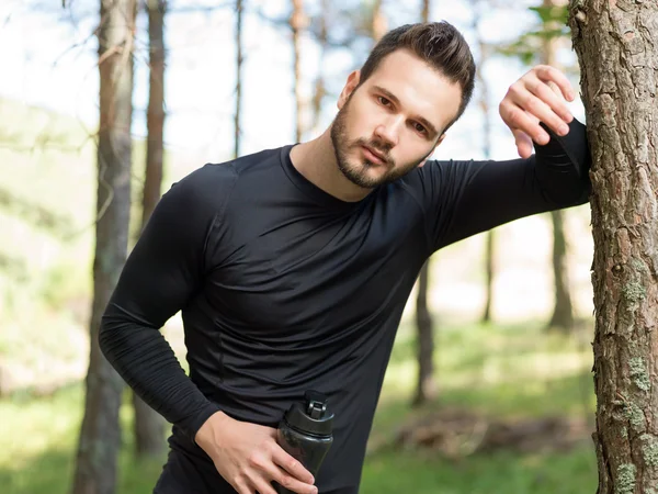 Athlete male runner running on mountain road. Running man joggin