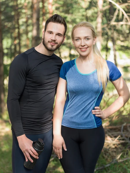 Portrait Of Male And Female Runners in nature