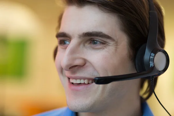 Young call center agent speaking with costumer