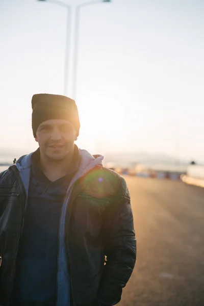 Hipster style guy. Fashion man on street palm at sunset