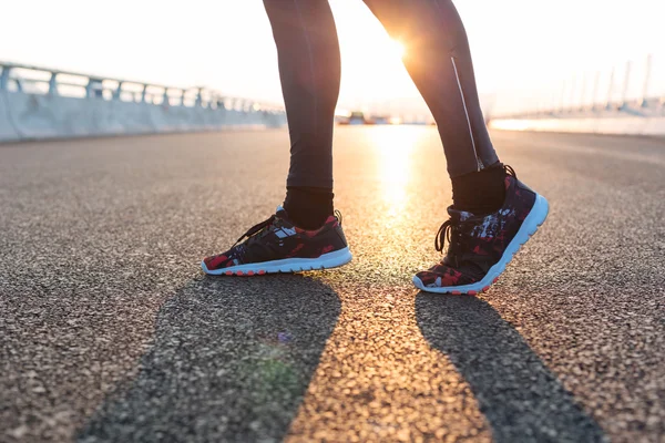 Fitness sunrise jog workout welness concept. Runner feet running
