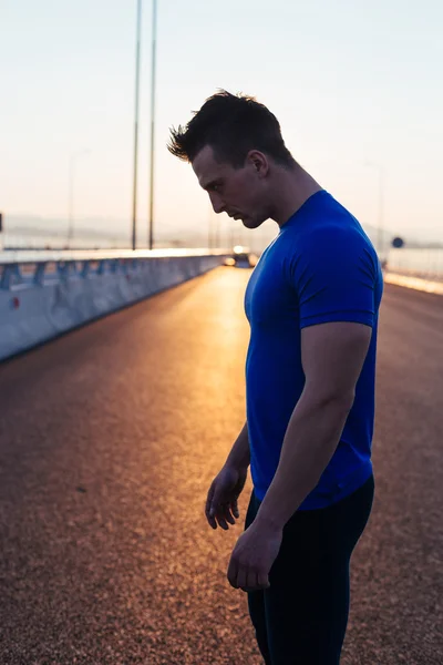 Half length portrait of muscular build handsome male posing for