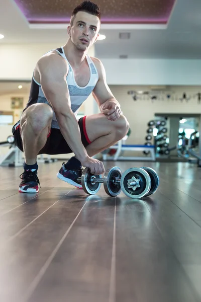 Athlete preparing himself for lifting weights in the modern gym