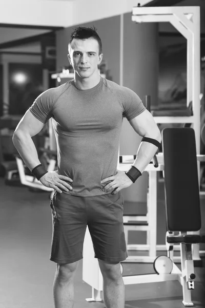 Portrait of muscular man with arms crossed in crossfit gym