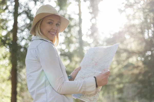 Traveler girl searching right direction on map, bright orange su