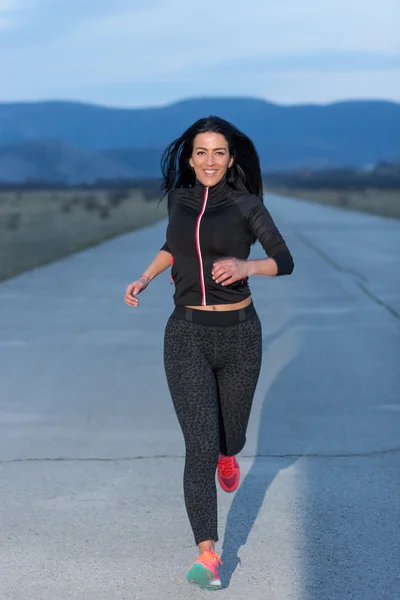 Young woman jogging at night in the city