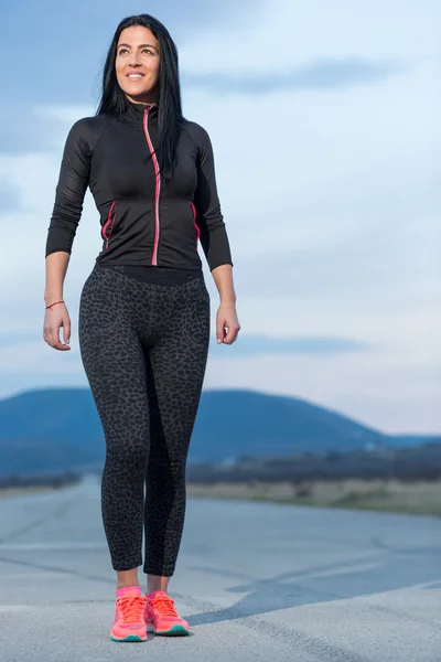 Young woman jogging at night in the city