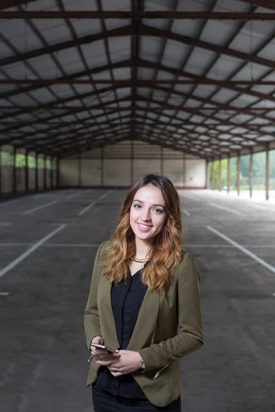 Business girl using phone at  future office building