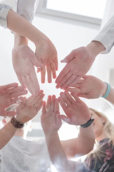 Students making a stack of hands