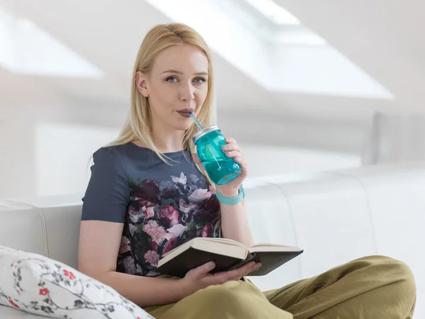 Woman at home with water bottle