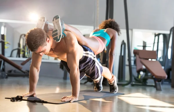 Man and woman doing exercise in gym