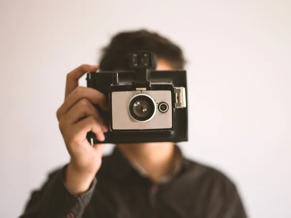 Young cool man with a camera