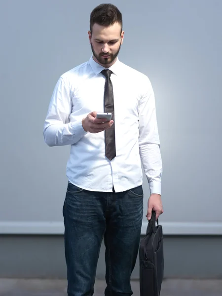Businessman using cellphone, handsome businessman on creative ba
