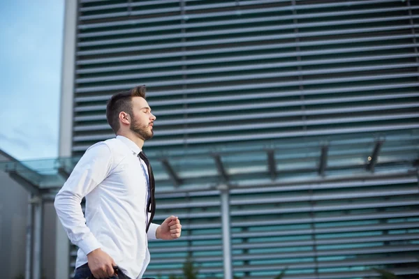 Friendly and smiling handsome businessman with beard running