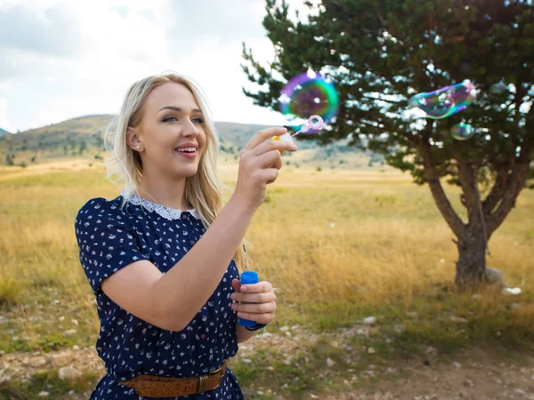 Woman blowing bubbles