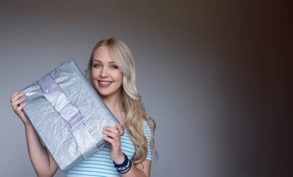 Young Beauty Blonde holding gift Box as a Present. Holiday