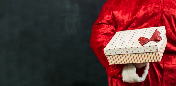 Holiday and special occasion. Closeup of santa hands. santa givi