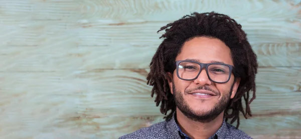 Studio portrait of cool black young man with black glasses, stri