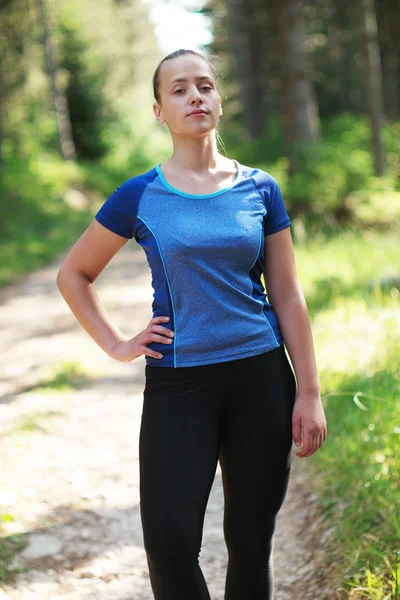 Attractive fit woman in sportswear training outdoors, female ath