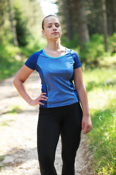 Attractive fit woman in sportswear training outdoors, female ath