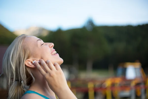 Running girl with earphones - woman runner listening to music in