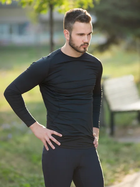 Portrait of Sport and fitness runner man resting on bridge after