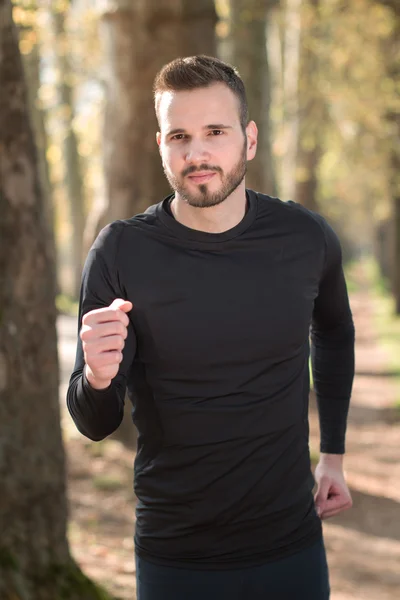 Running fitness man sprinting outdoors in beautiful landscape. F