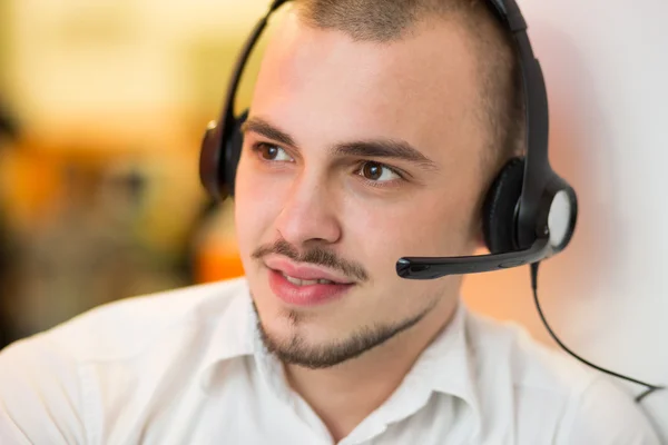 Portrait of happy smiling customer support phone operator in hea