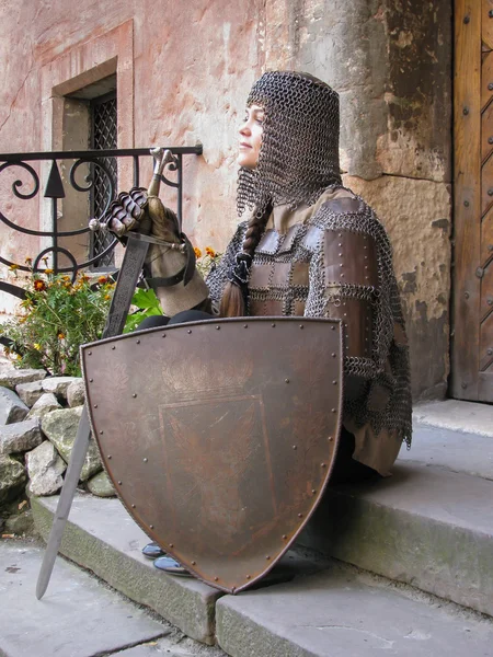Women in a knight armor with a shield
