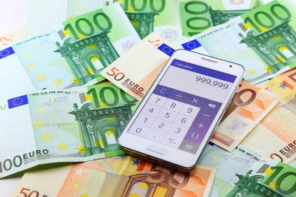 Smart mobile phone open calculator application with euro banknotes on background. Making money online