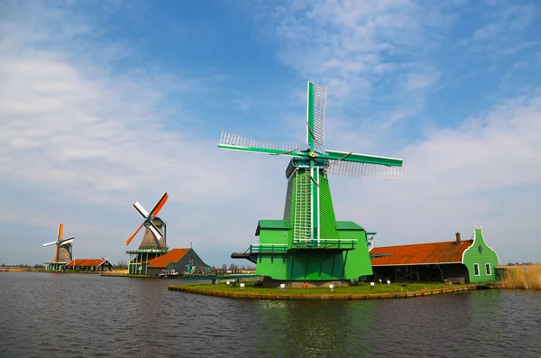 Unique, old, authentic, traditional and colorful dutch windmills along the canal in the suburb area of The Netherlands