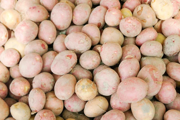 Potatoes on the counter market for sale as a background