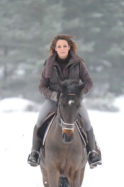 Young woman riding in the snow