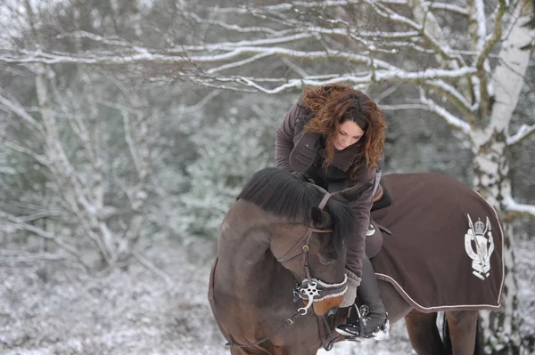 Young woman riding in the snow