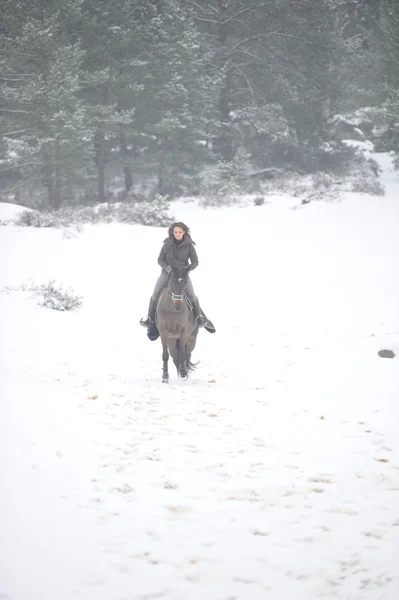 Young woman riding in the snow