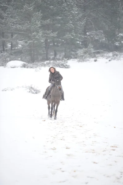 Young woman riding in the snow