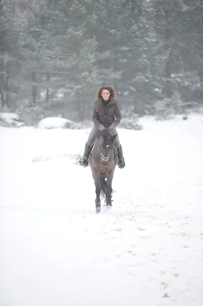 Young woman riding in the snow