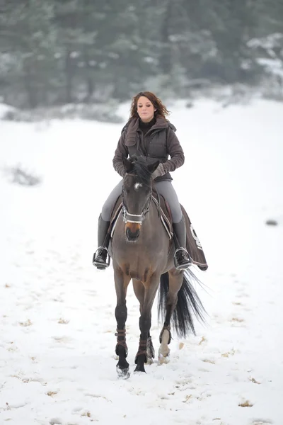 Young woman riding in the snow