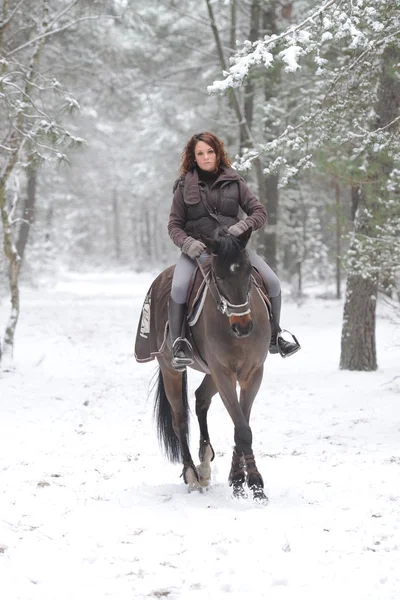 Young woman riding in the snow