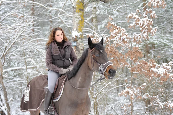 Young woman riding in the snow