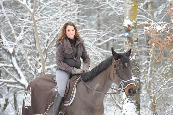 Young woman riding in the snow