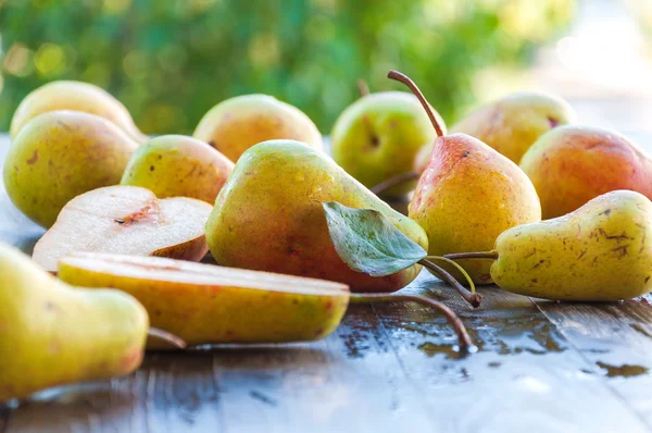 Ripe juicy pear, pear on a wooden table in the garden.