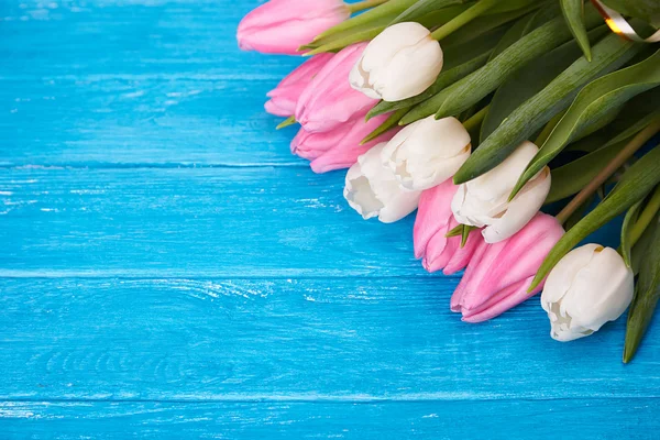 White tulips on white wooden background