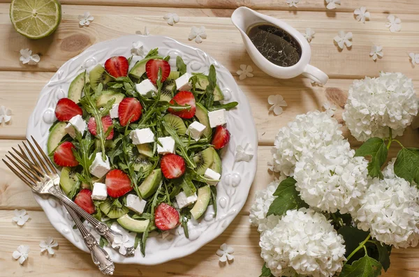 Salad with avocado kiwi strawberry feta and arugula