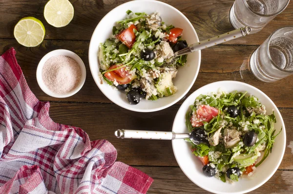 Couscous salad with tomatoes and arugula fish olives avocados