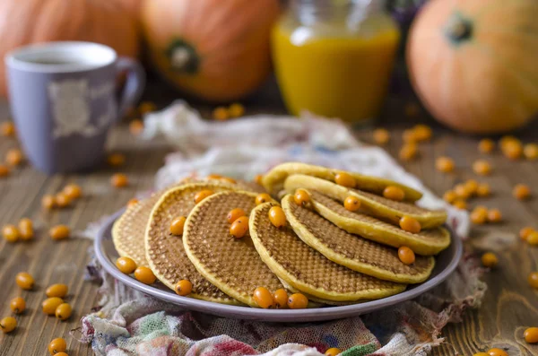 Pumpkin pancakes with sea buckthorn sauce for breakfast